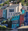 a row of brightly painted houses on a hill